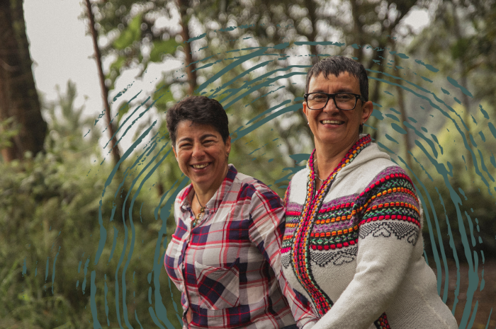 Two women walking in a forest