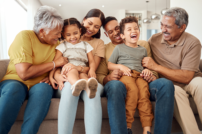 Multigenerational family sitting on a couch together