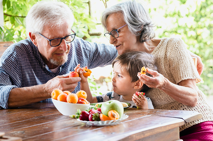 Grandparents with child at breakfast table